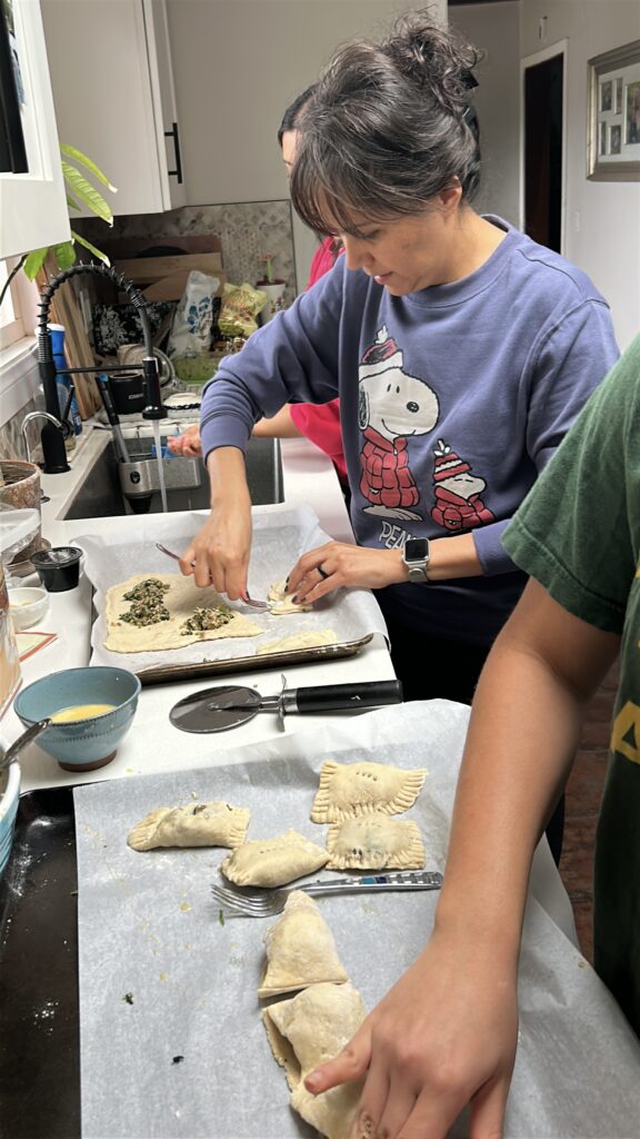 Families making fresh ravioli during Holiday Ravioli Workshop at Cocina Uccellino, Fallbrook